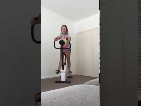 girl falls off exercise bike